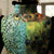 Chaleco acolchado estilo chino con cuello y borde de piel con estampado de plumas de pavo real
