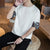 Chinesisches T-Shirt aus Baumwolle mit Rundhalsausschnitt und Brokatbündchen