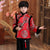 Traje acolchado de niño de estilo chino con borde de piel de brocado de patrón auspicioso