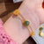 Bracelet de style chinois avec pendentif en jade vert et personnage de Fu Dorée